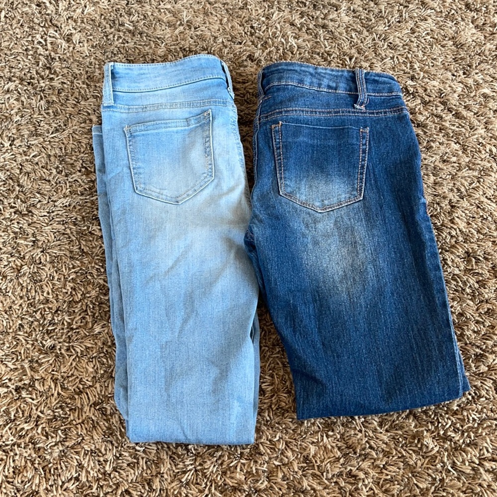 2 pairs of jeans, light blue are a size 14 the dark blue are a size 16.